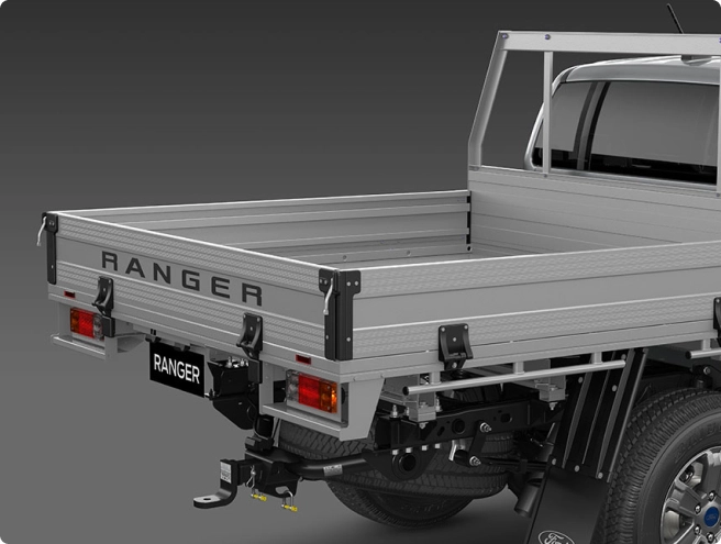 Rear view of a silver Ford Ranger pickup truck with an aluminum flatbed utility tray, featuring "RANGER" branding.