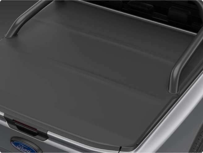 Top-down view of a grey Ford Ranger truck bed with a closed, smooth black tonneau cover.