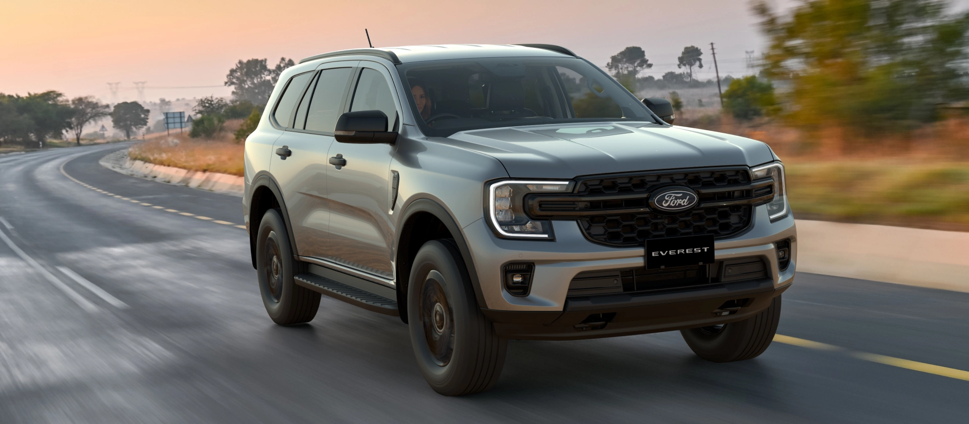 Ford Everest Active in Silver shown driving on an open road