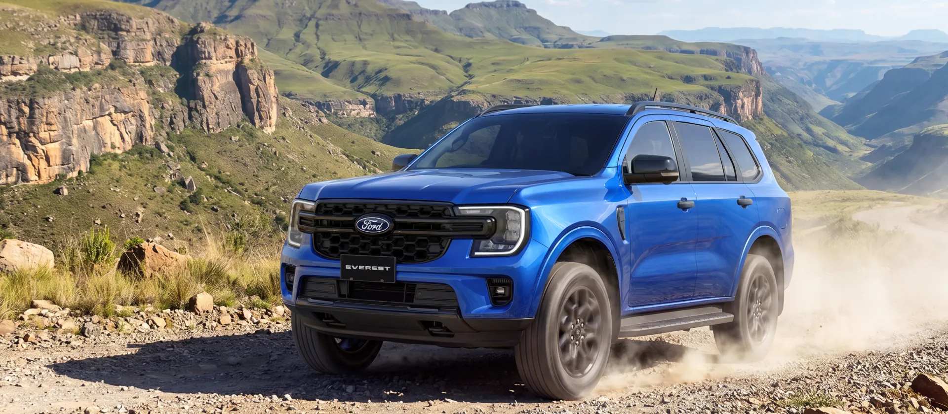 Rear view of blue lightning Ford Everest Sport on rocky ground