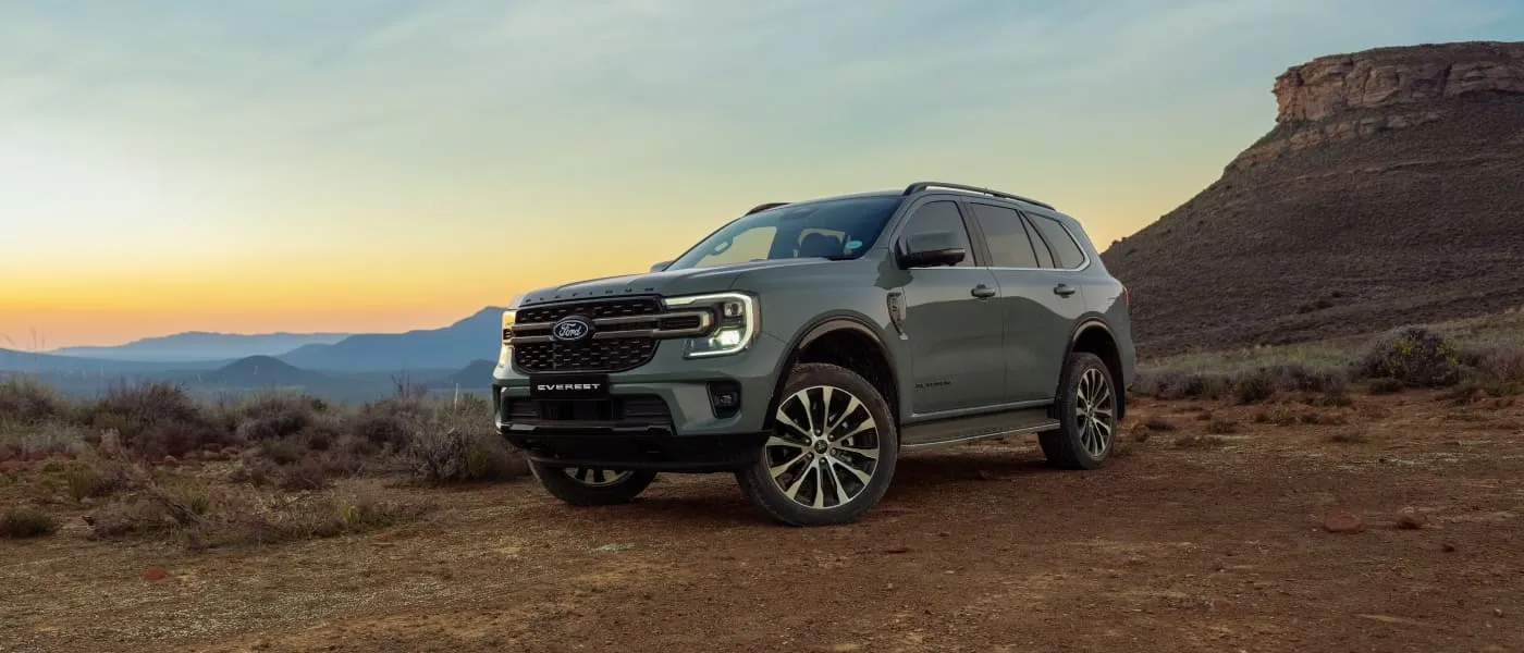 Silver Ford Everest SUV on a rugged desert trail at sunset