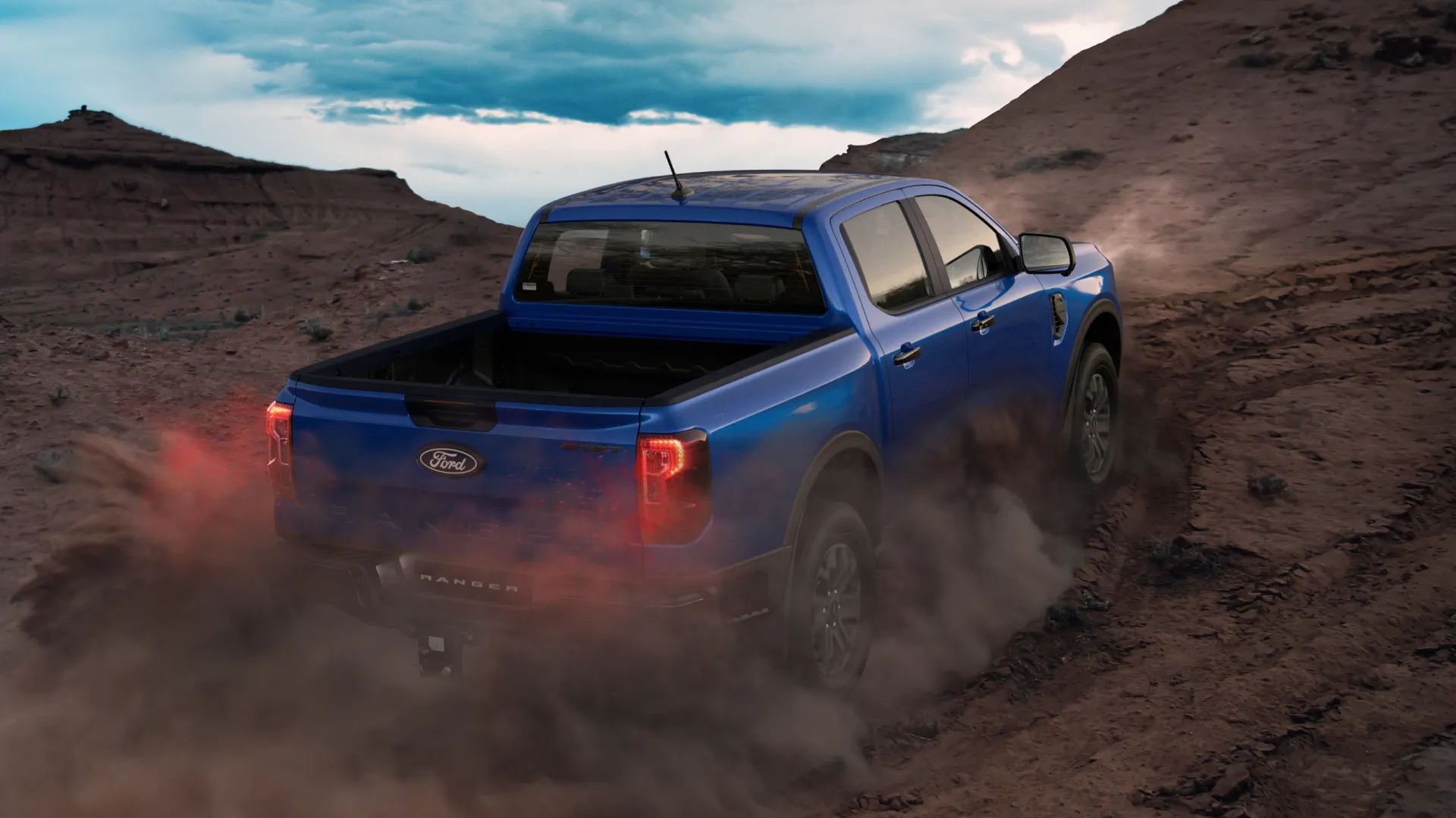 Ford Ranger driving on rocky off road terrain.