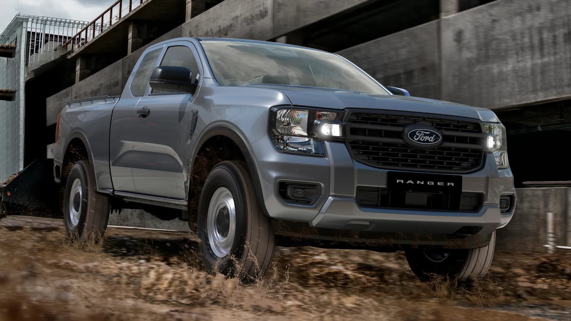 Ford Ranger single cab driving through muddy terrain.