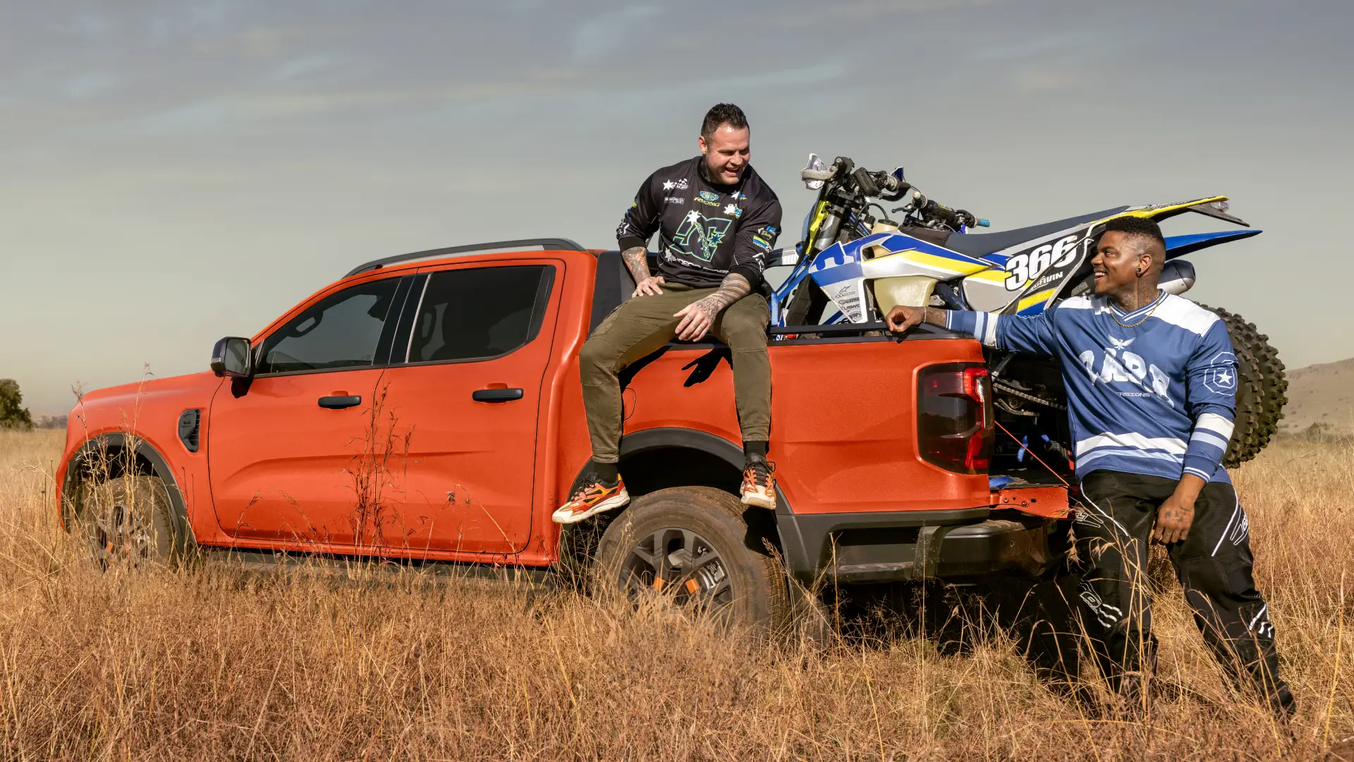 ford ranger carrying dirt bike in field