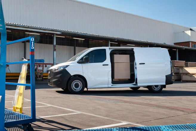 Loaded white Ford Transit van at warehouse loading dock