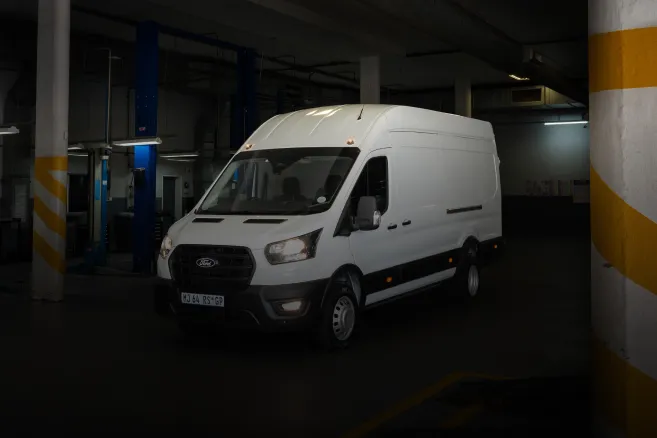 White Ford Transit van parked in a garage